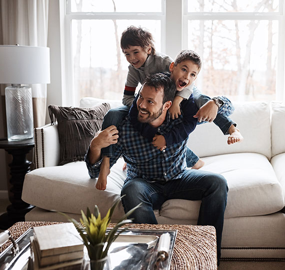 Father playing with family after a Bridge Loan from Berkley Bank